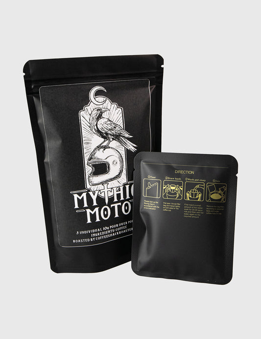 Two black coffee bags with branding on a light gray background. travel pour over coffee