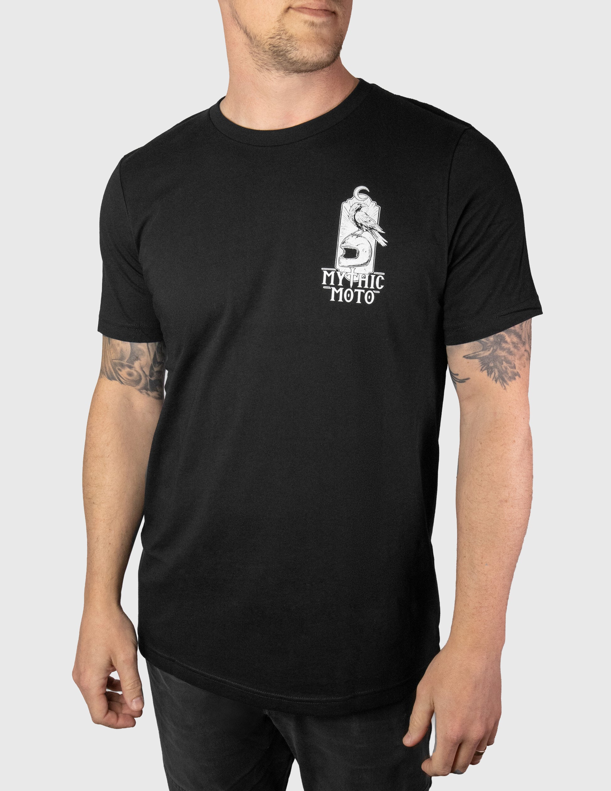 Person wearing a black t-shirt with a logo on a white background