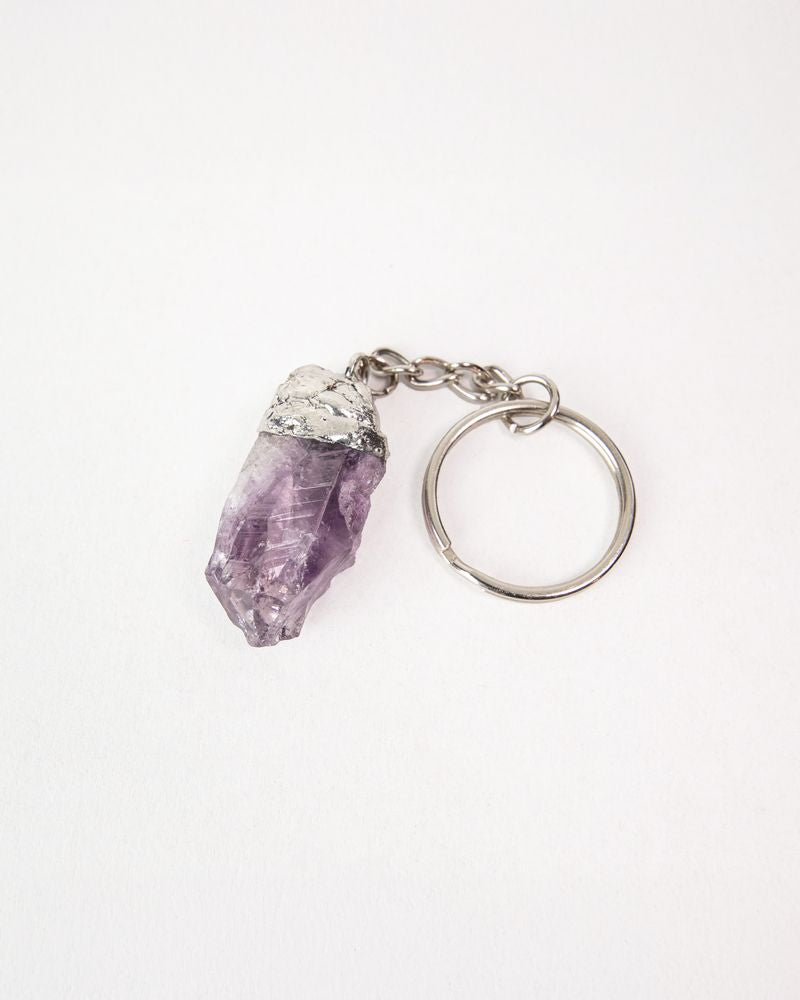 Amethyst keychain with crystal pendants on a white background. Protection Stone, Guardian Bell, Mythic Moto, Her Two Wheels