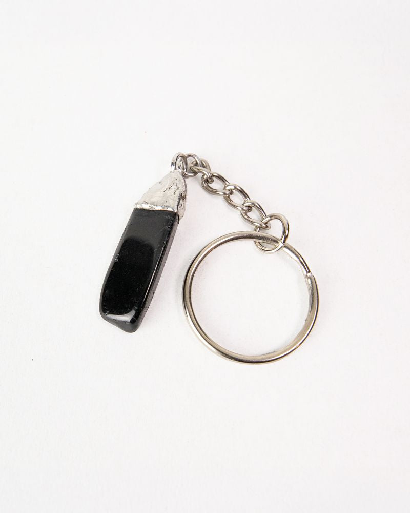 Keychain with a black tourmaline stone and silver ring on a white background. Mythic Moto, Her Two Wheels, Guardian Bell