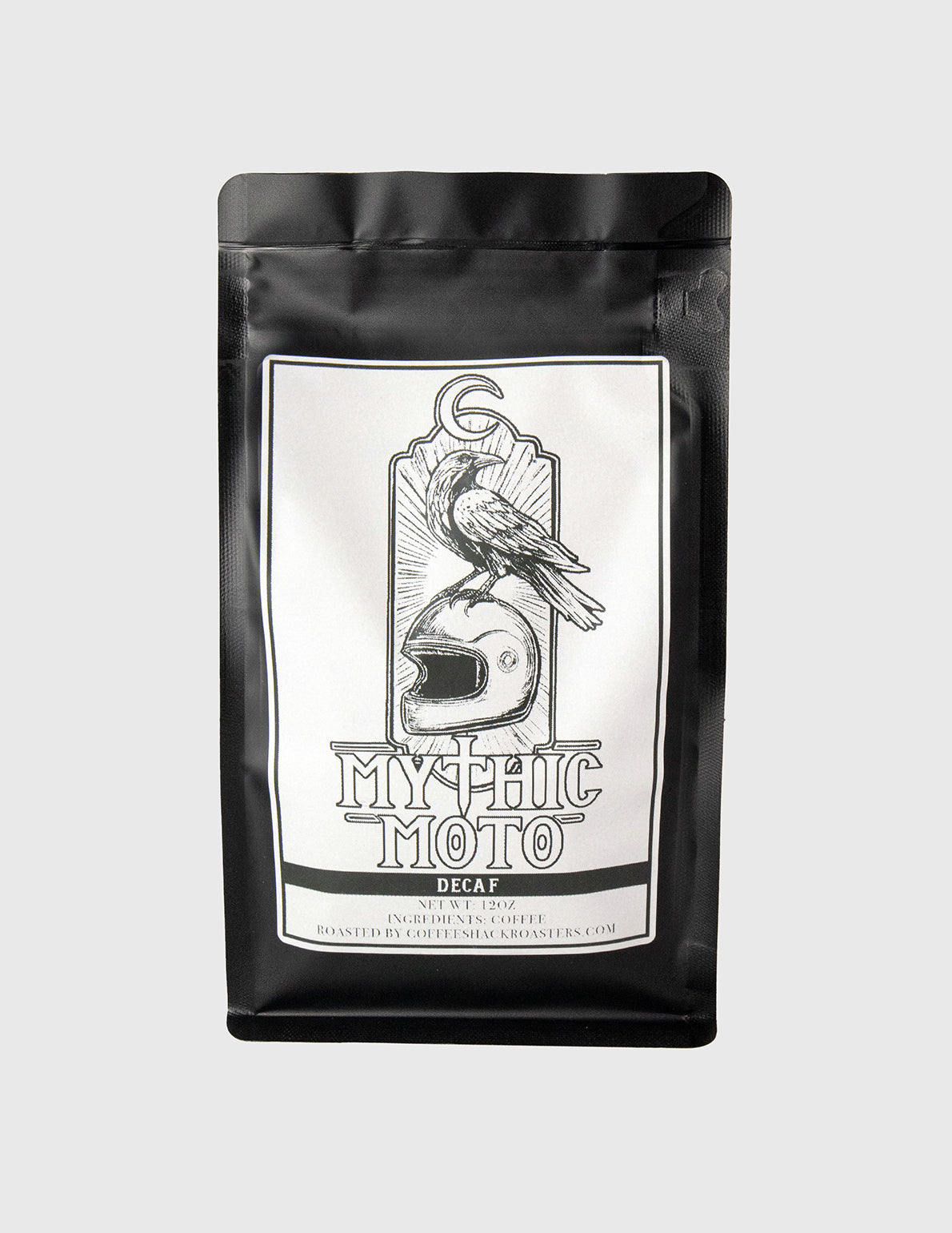 Decaf Espresso Blend Dark Roast Ground Black coffee bag with a white label featuring a graphic design and text on a light gray background