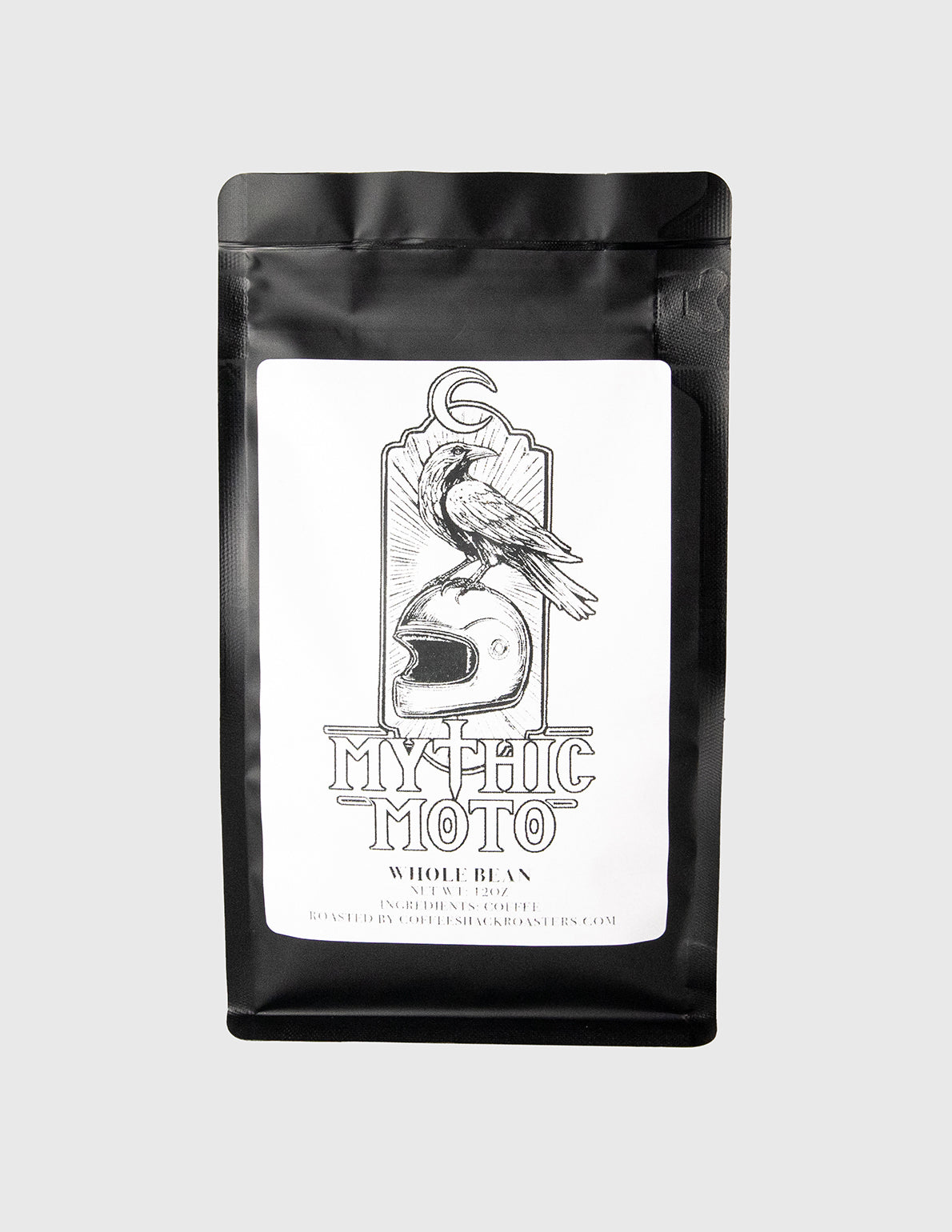 Black coffee bag with 'Mythic Moto' label featuring a motorcycle helmet and bird illustration on a white background. whole bean