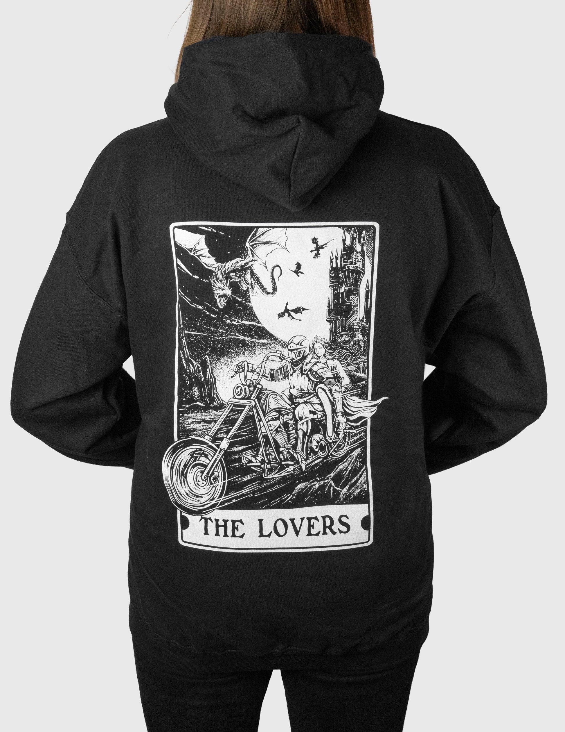 Black hoodie with 'The Lovers' tarot card design on the back, worn by a woman.