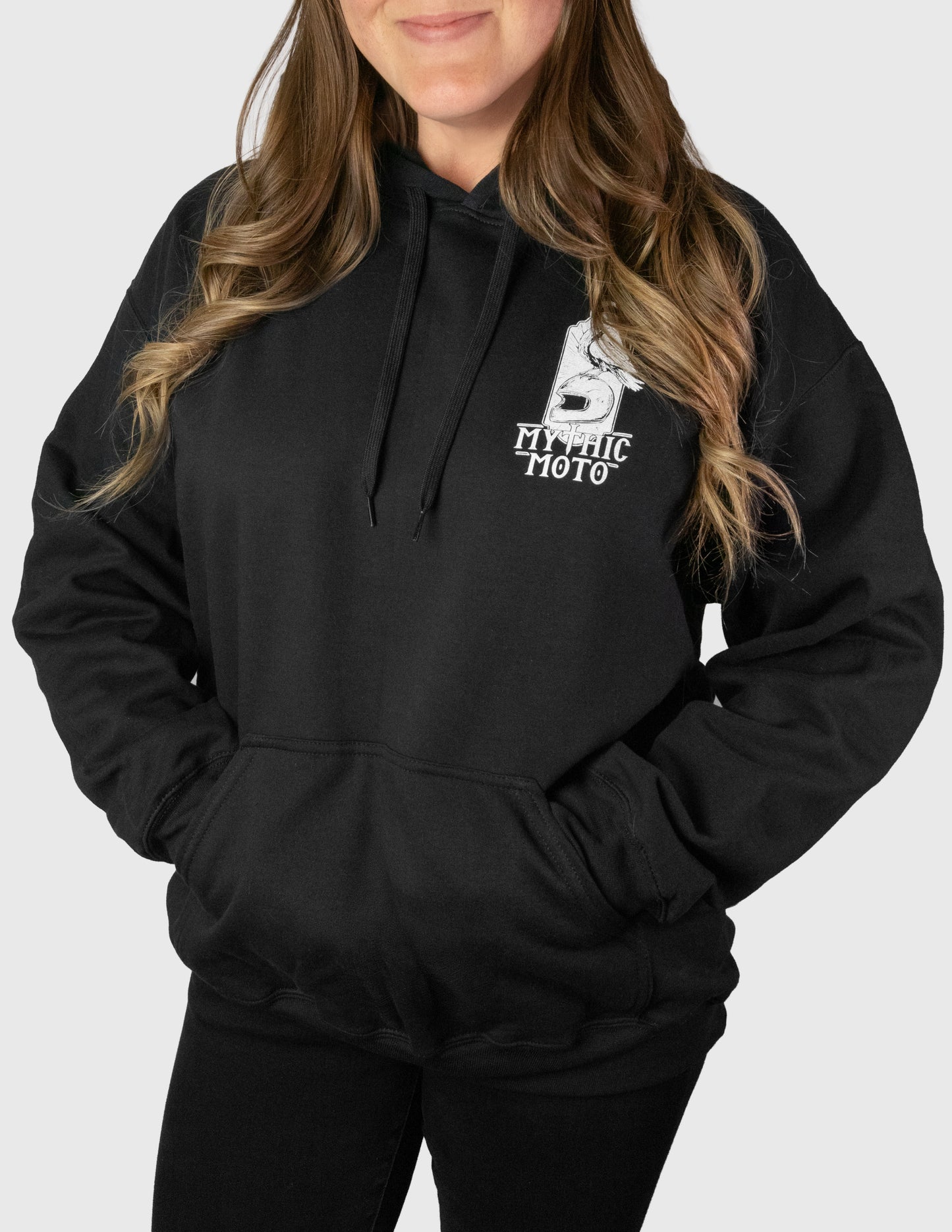 Woman wearing a black hoodie with a logo and text on a white background