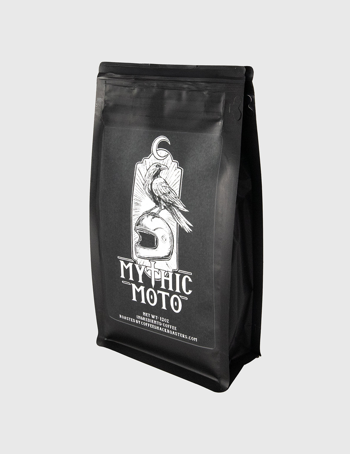 Black coffee bag with 'Mythic Moto' branding on a light gray background