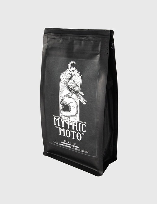Black coffee bag with 'Mythic Moto' branding on a light gray background