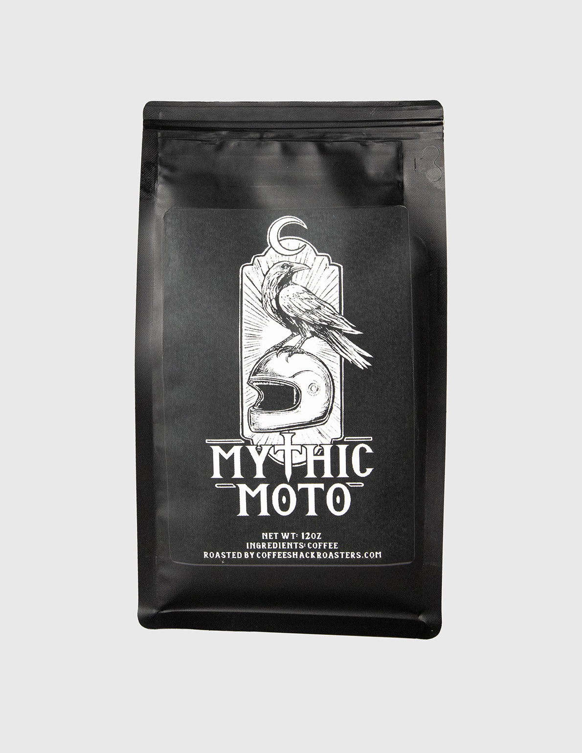 Black coffee bag with 'Mythic Moto' branding on a light gray background