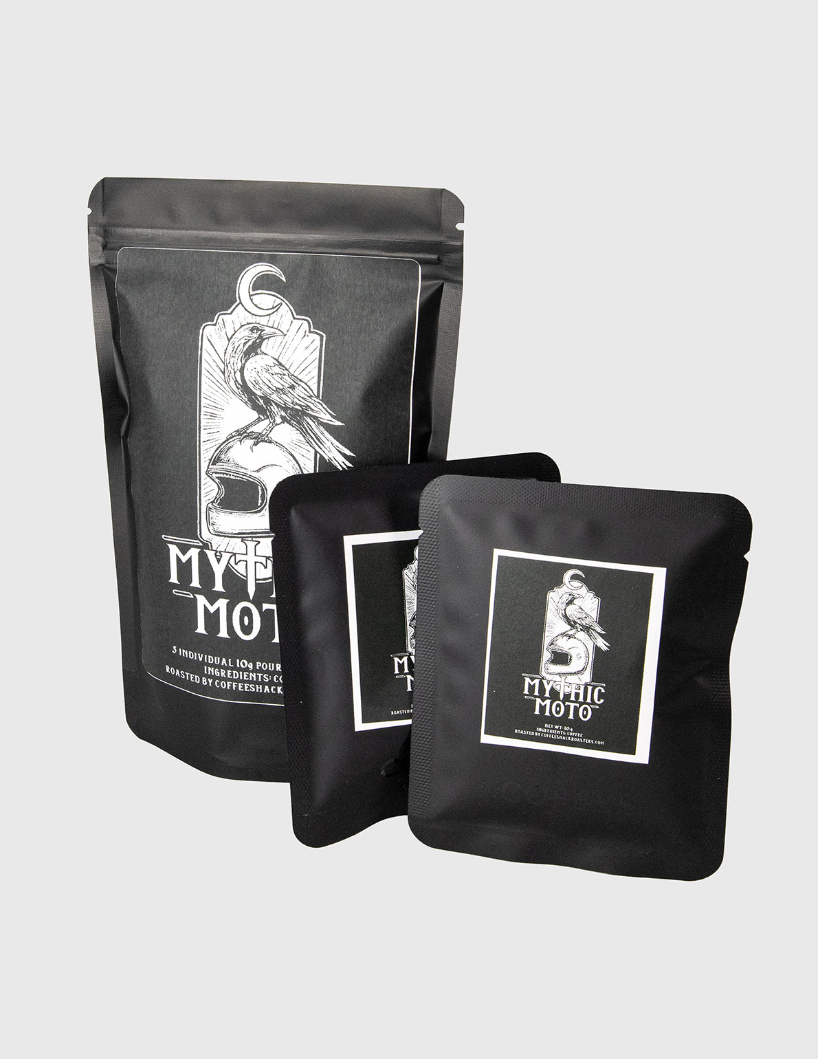 Black coffee bags with white graphics and text on a light gray background. travel coffee pour over