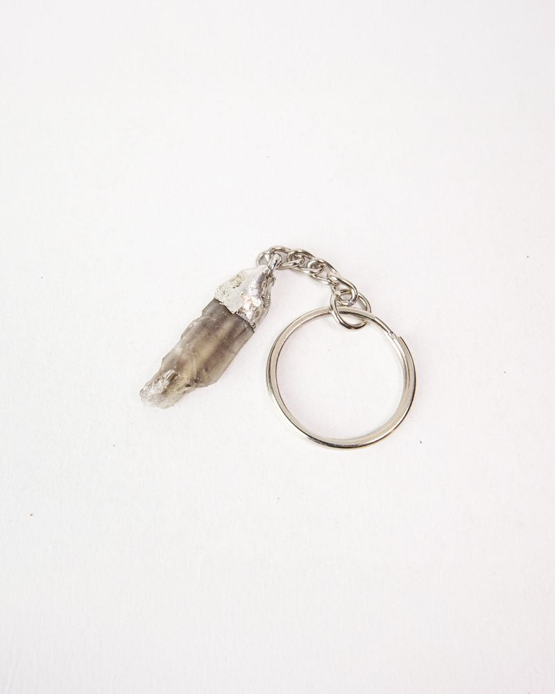 Keychain with a Smoky Quartz crystal on a white background. Her Two Wheels, Guardian Bell, Gremlin Bell, Mythic Moto