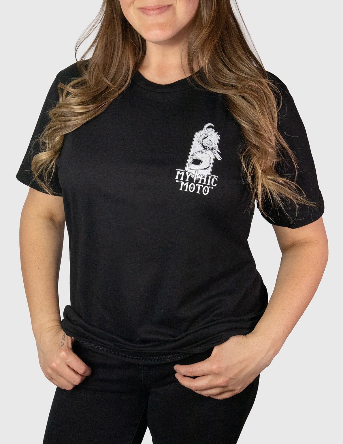 Person wearing a black t-shirt with a logo on a white background. Her Two Wheels